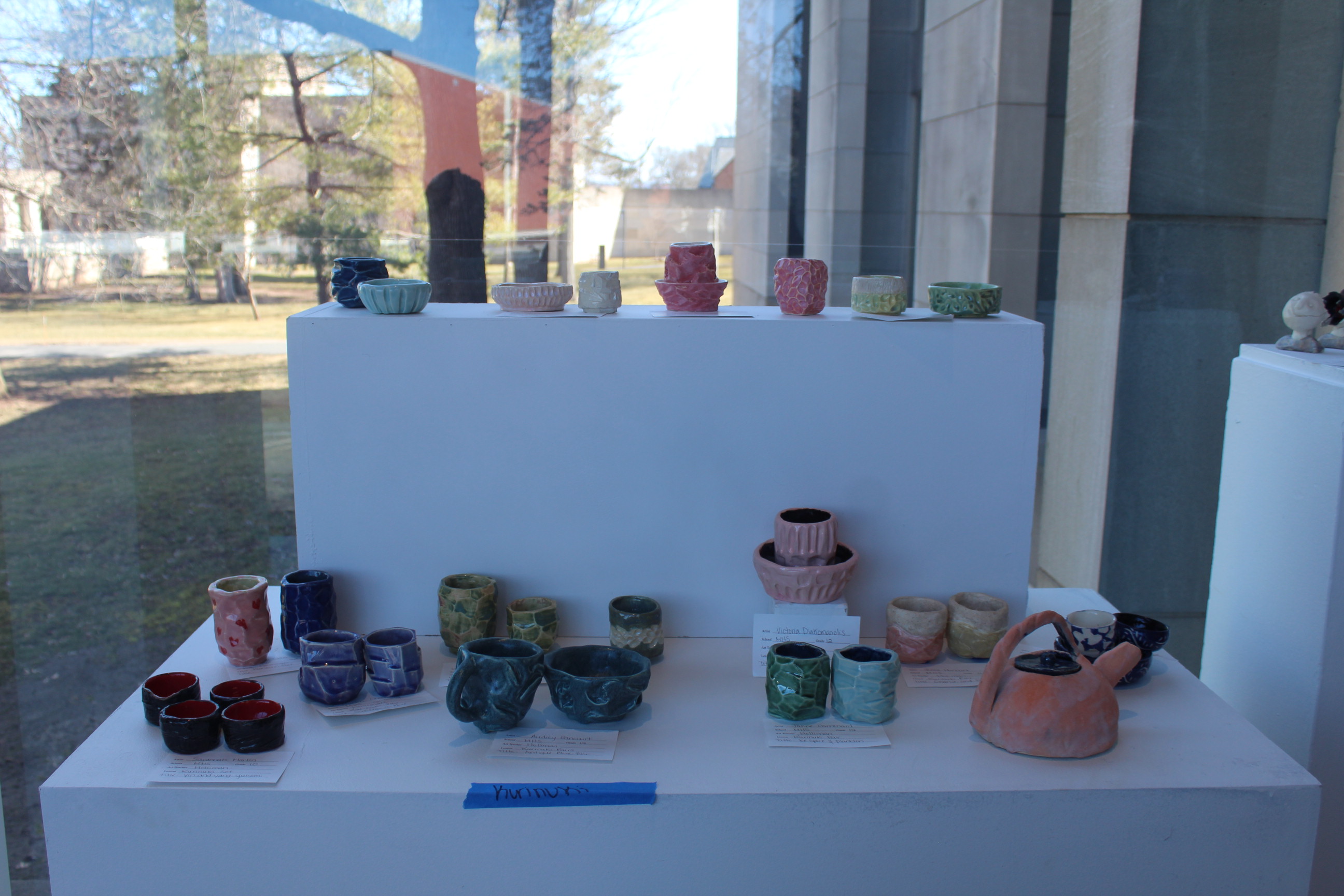 Student pottery on display in the gallery